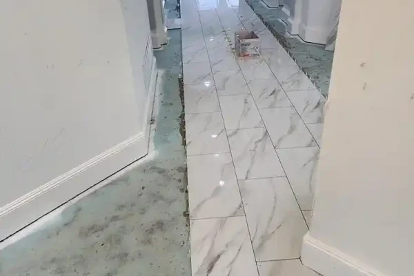 Spreading with trowel floor glue. View from above.