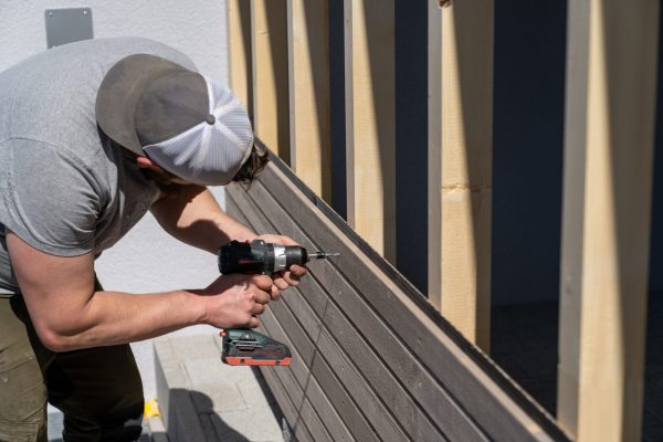 a-tough-construction-worker-applies-wooden-siding-2025-10-16-22-08-13-utc (1)