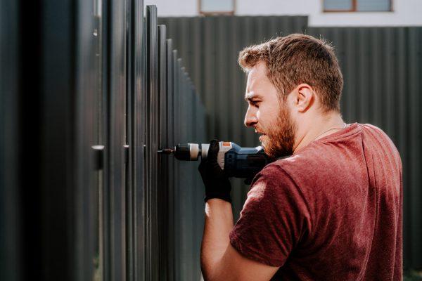 worker working with an electric screwdriver on the construction site